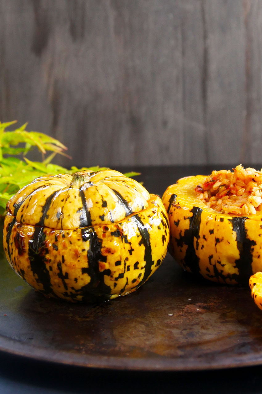 Baked minikin pumpkins stuffed with pearl barley for a healthy meat free meal