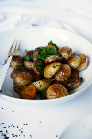 Quick crispy potatoes - ready in no time and lightly spiced with nigella seeds, cumin seeds and coriander seeds.